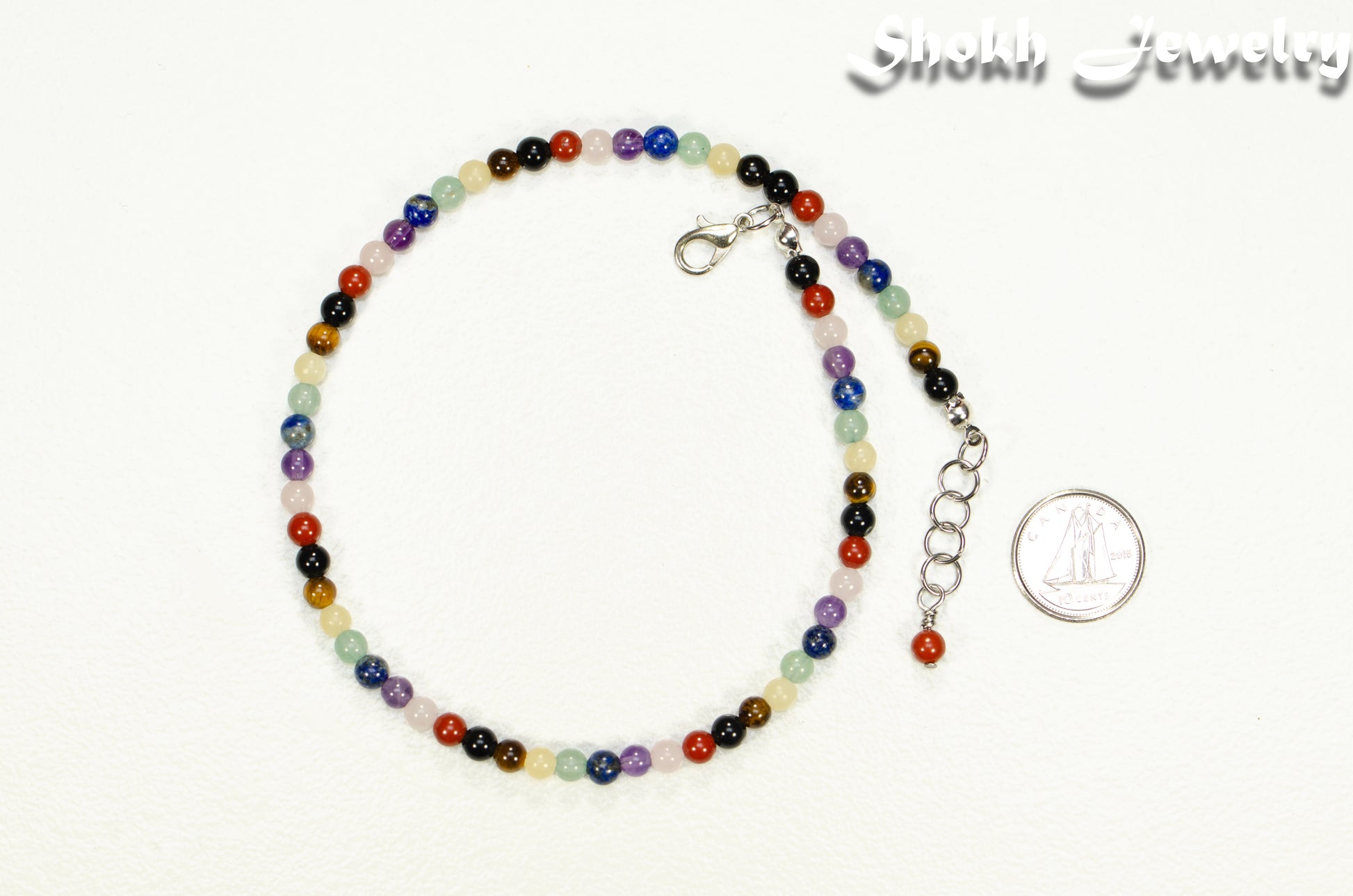 4mm Chakra Gemstone Choker Necklace beside a dime.
