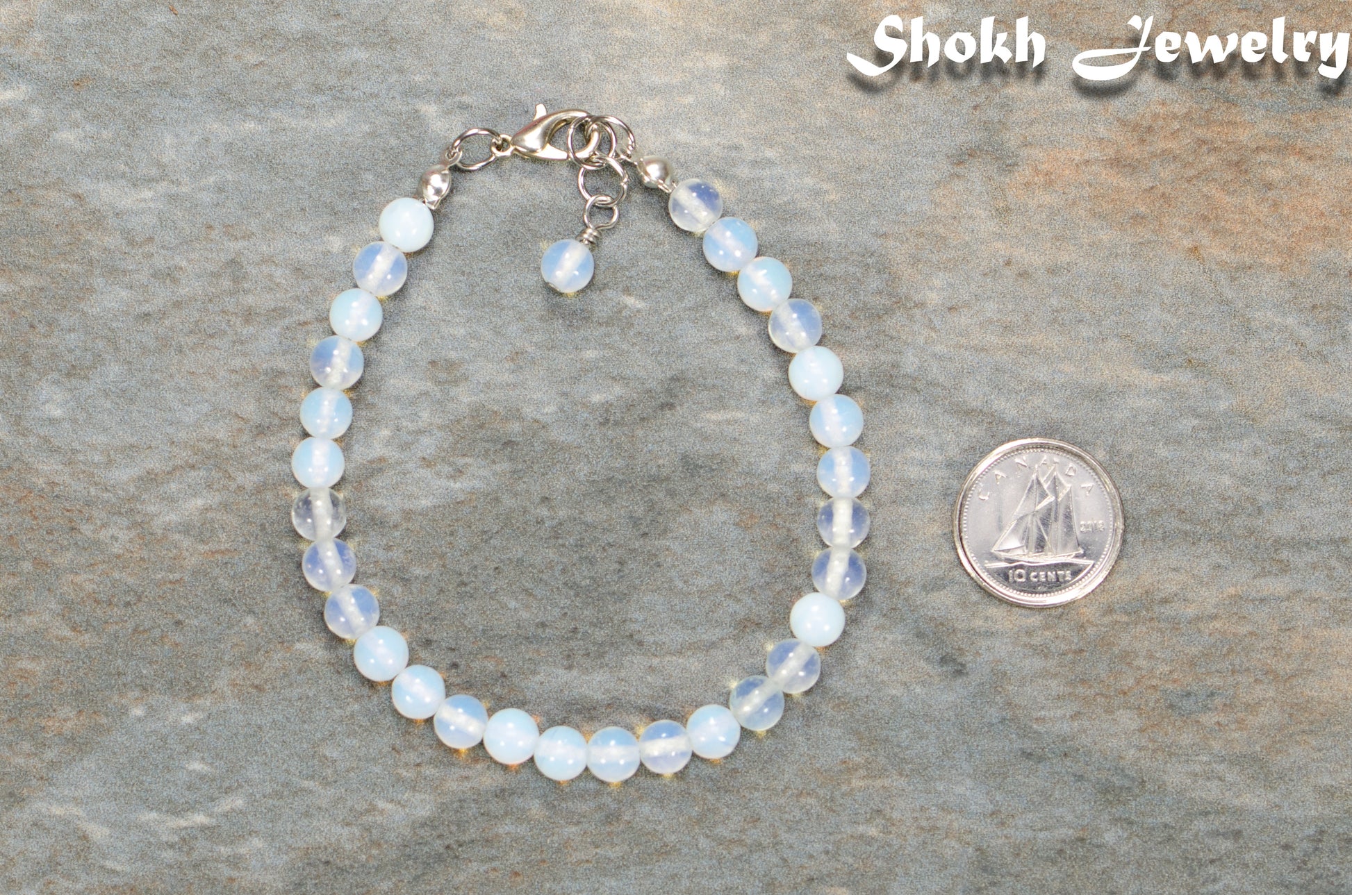 6mm Clear White Opalite Beaded Bracelet beside a dime.