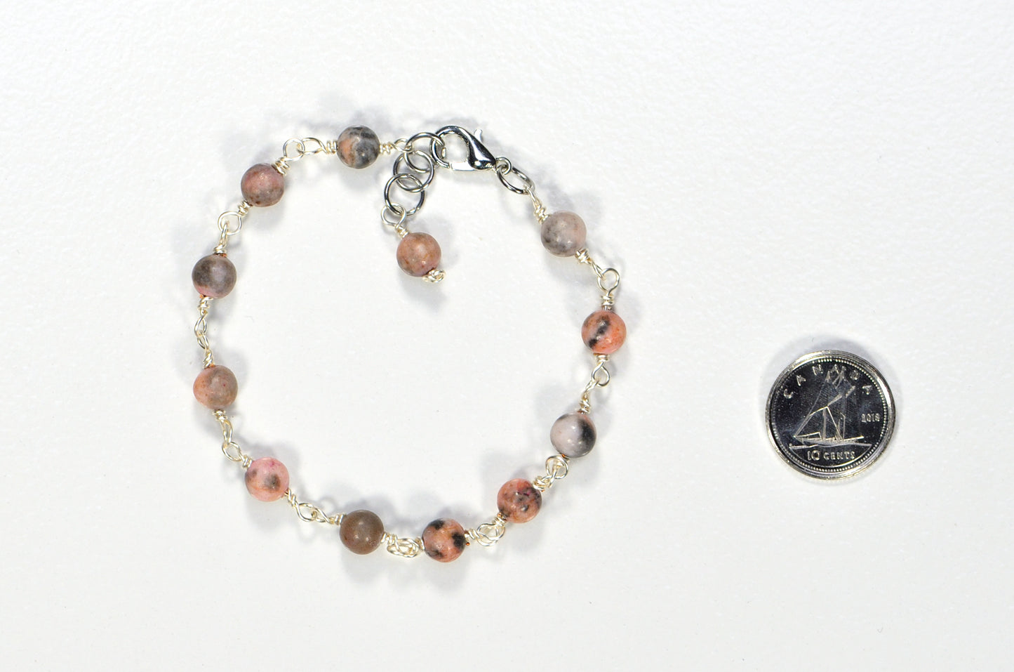 6mm Pink Zebra Jasper Link Bracelet eside a dime.