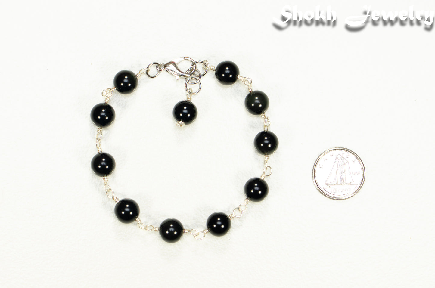 8mm Black Obsidian Link Anklet beside a dime.