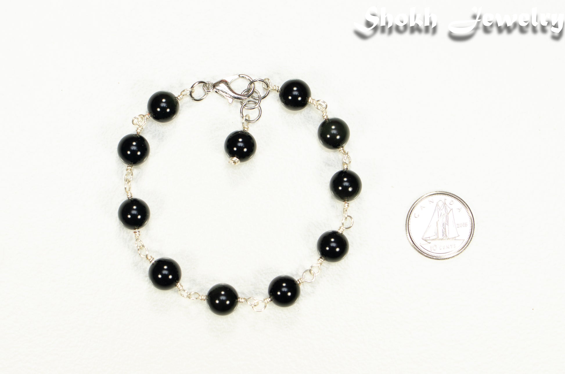 8mm Black Obsidian Link Anklet beside a dime.