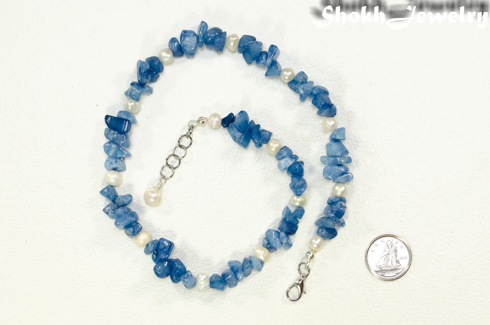 Freshwater Pearl and Natural Blue Quartzite Chip Choker Necklace beside a dime.