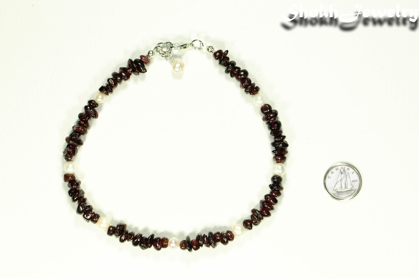 Freshwater Pearls and Garnet Crystal Chip Choker Necklace beside a dime.