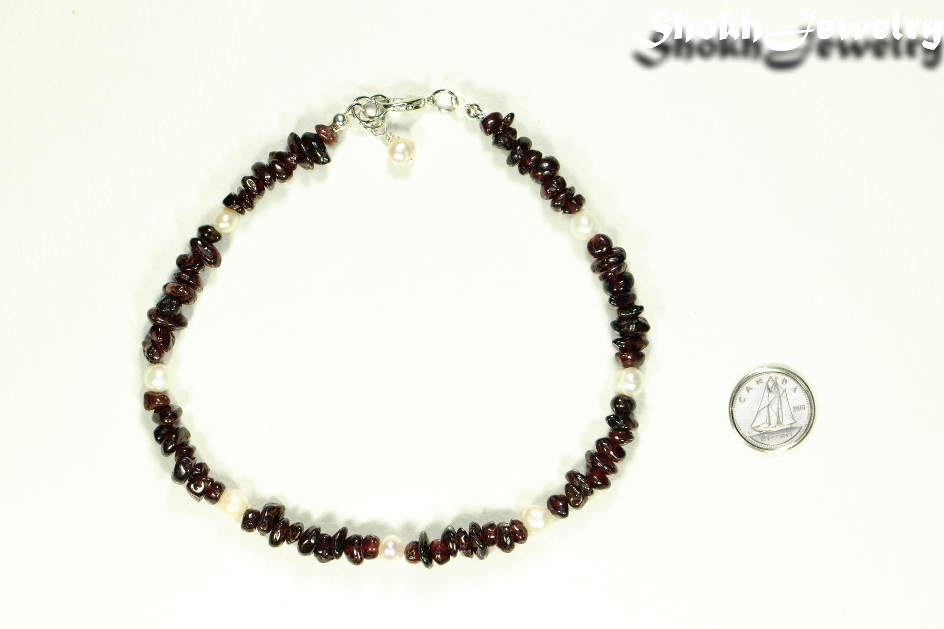 Freshwater Pearls and Garnet Crystal Chip Choker Necklace beside a dime.