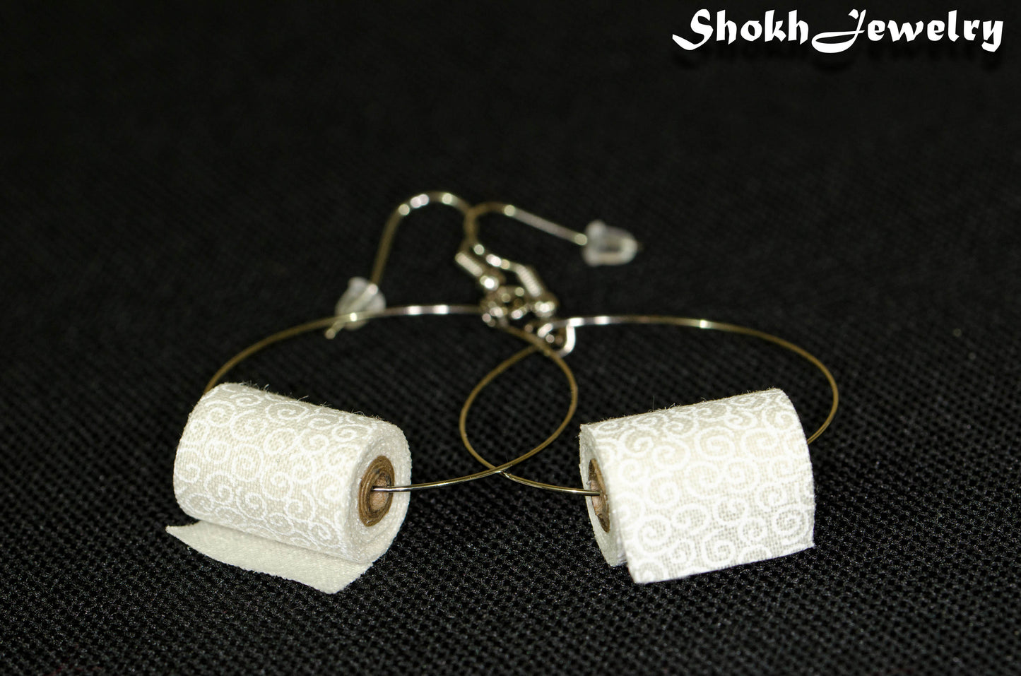 Close up of Miniature Toilet Paper Roll Earrings.