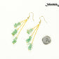 Long Gold Plated Chain and Green Aventurine Chip Earrings beside a dime.