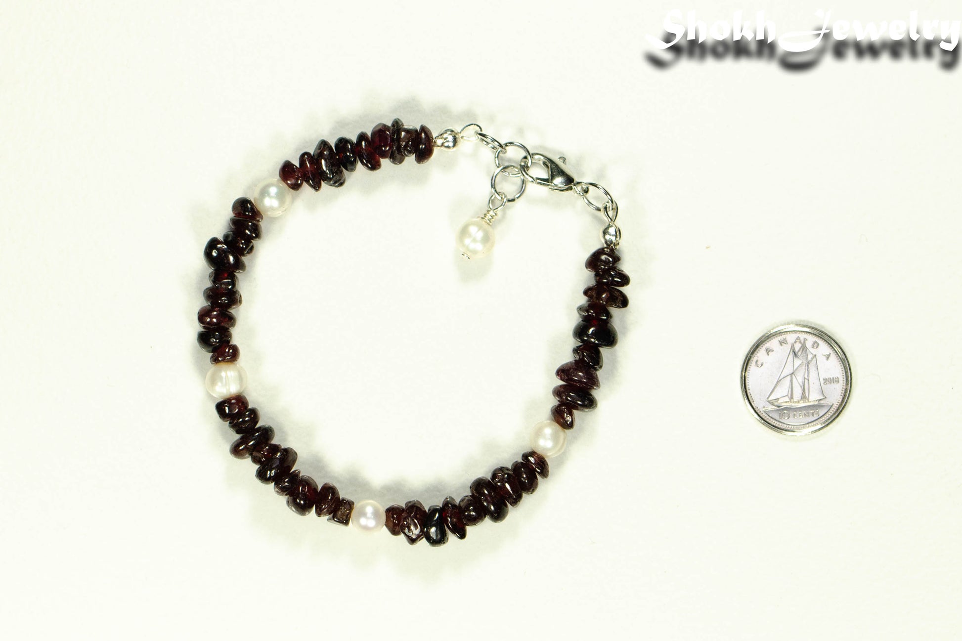 Natural Garnet Crystal Chip and Pearls Bracelet beside a dime.