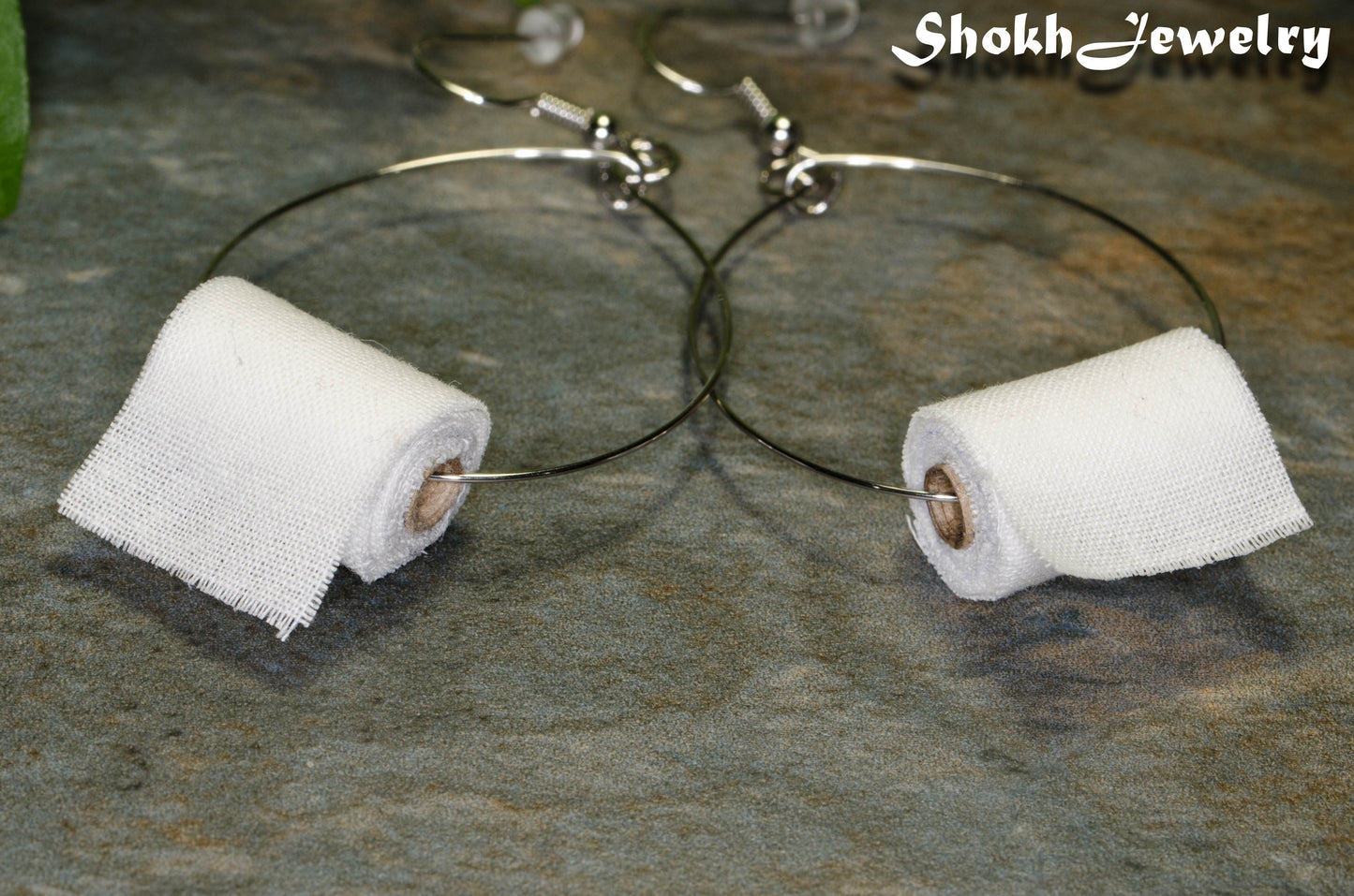 Close up of Miniature Toilet Paper Roll Earrings.