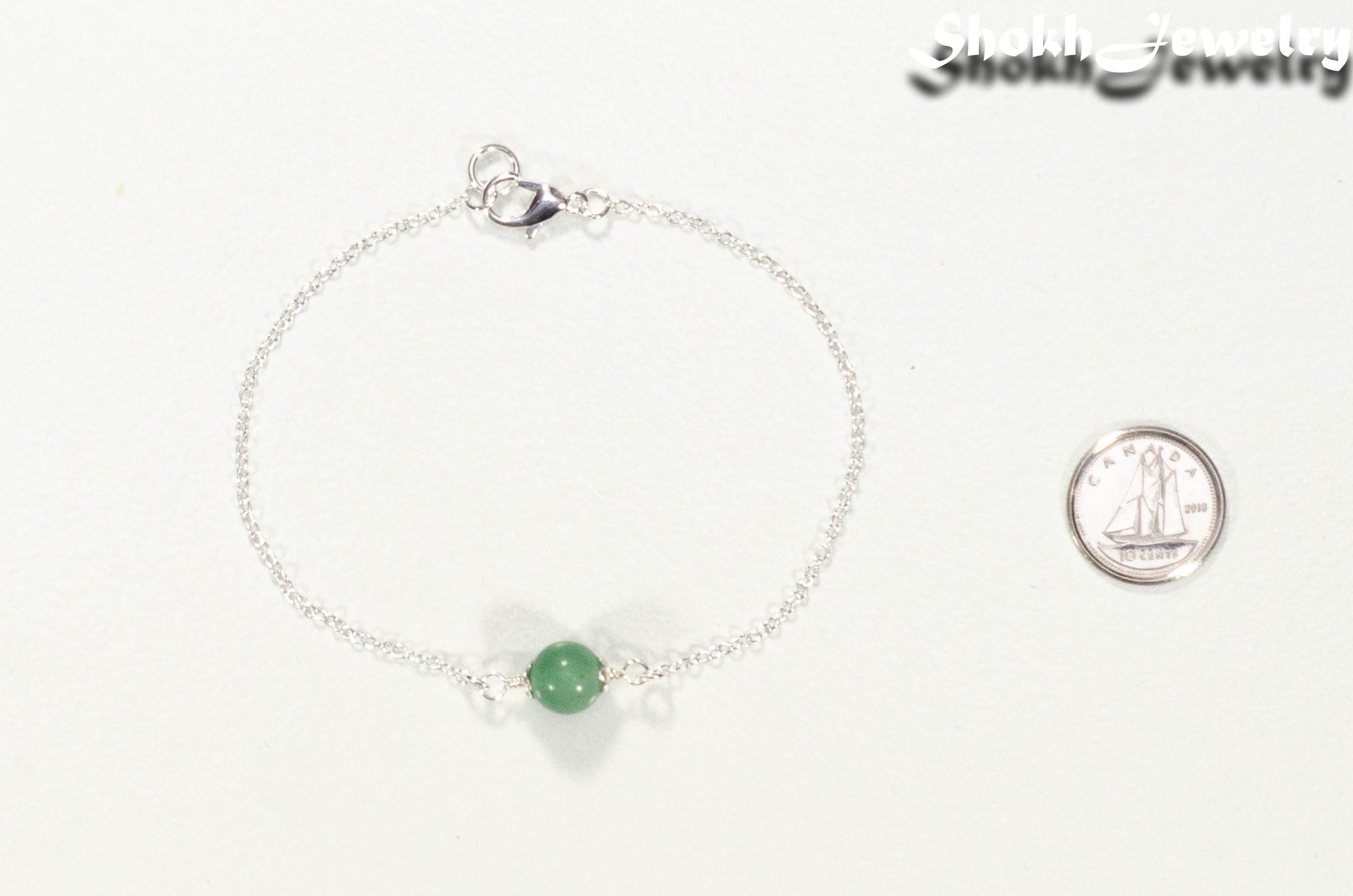 Minimal Green Aventurine Bracelet beside a dime.