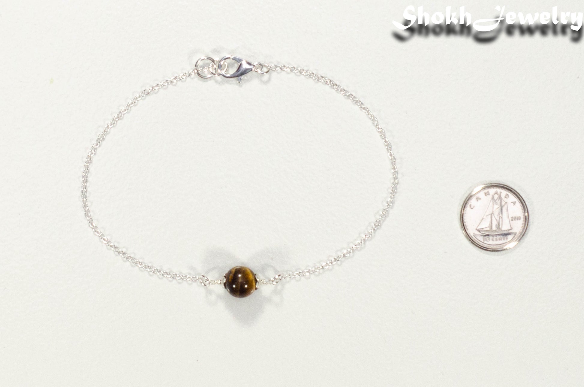 Minimal Tiger's Eye Bracelet beside a dime.