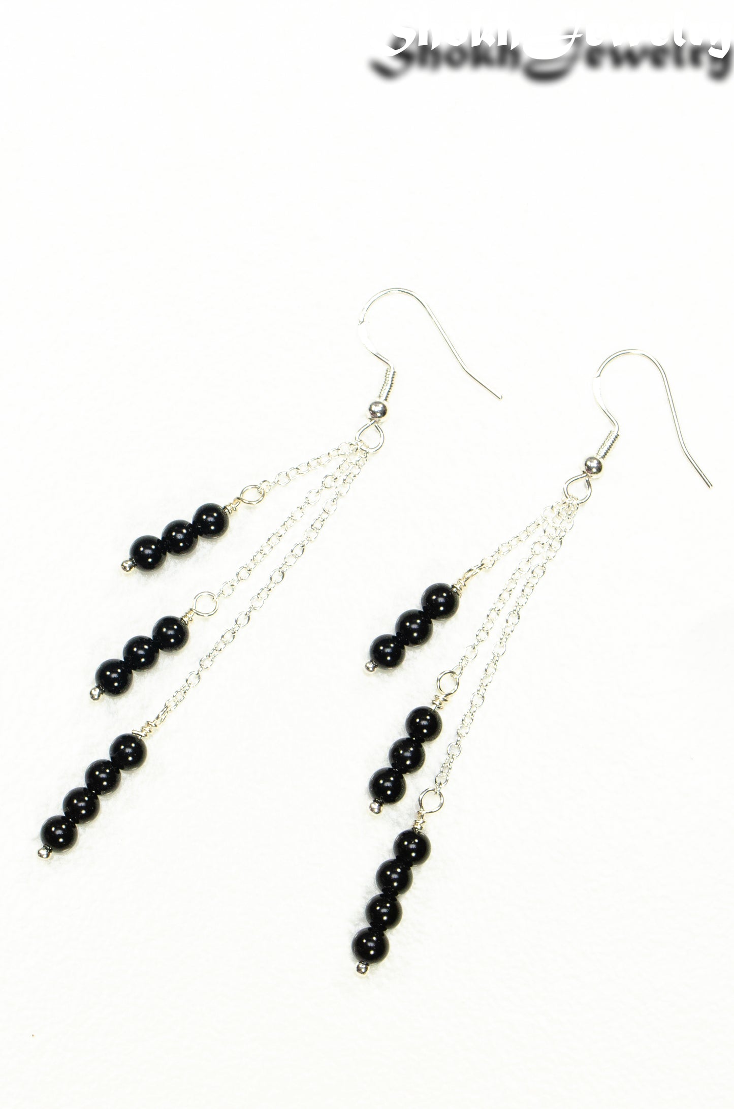 Top view of Silver Plated Chain and Black Obsidian Crystal Earrings.