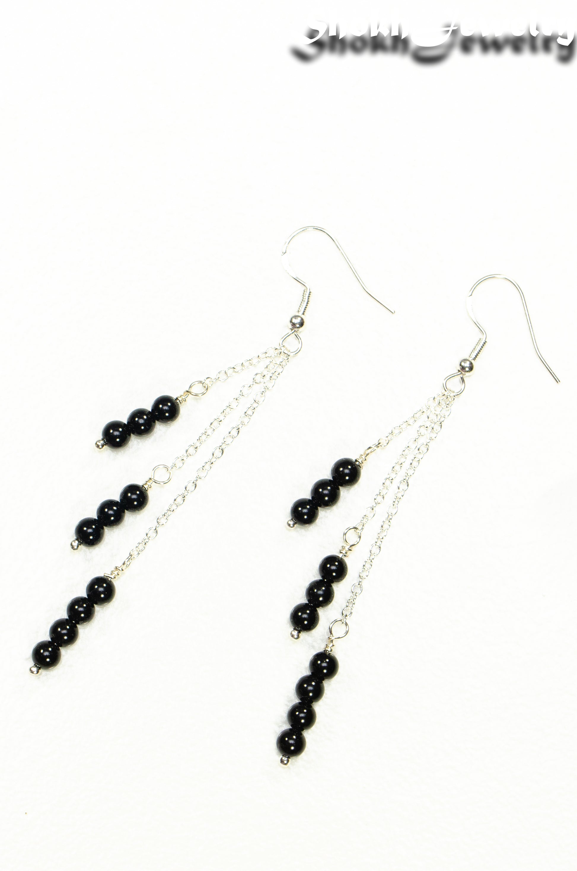 Top view of Silver Plated Chain and Black Obsidian Crystal Earrings.