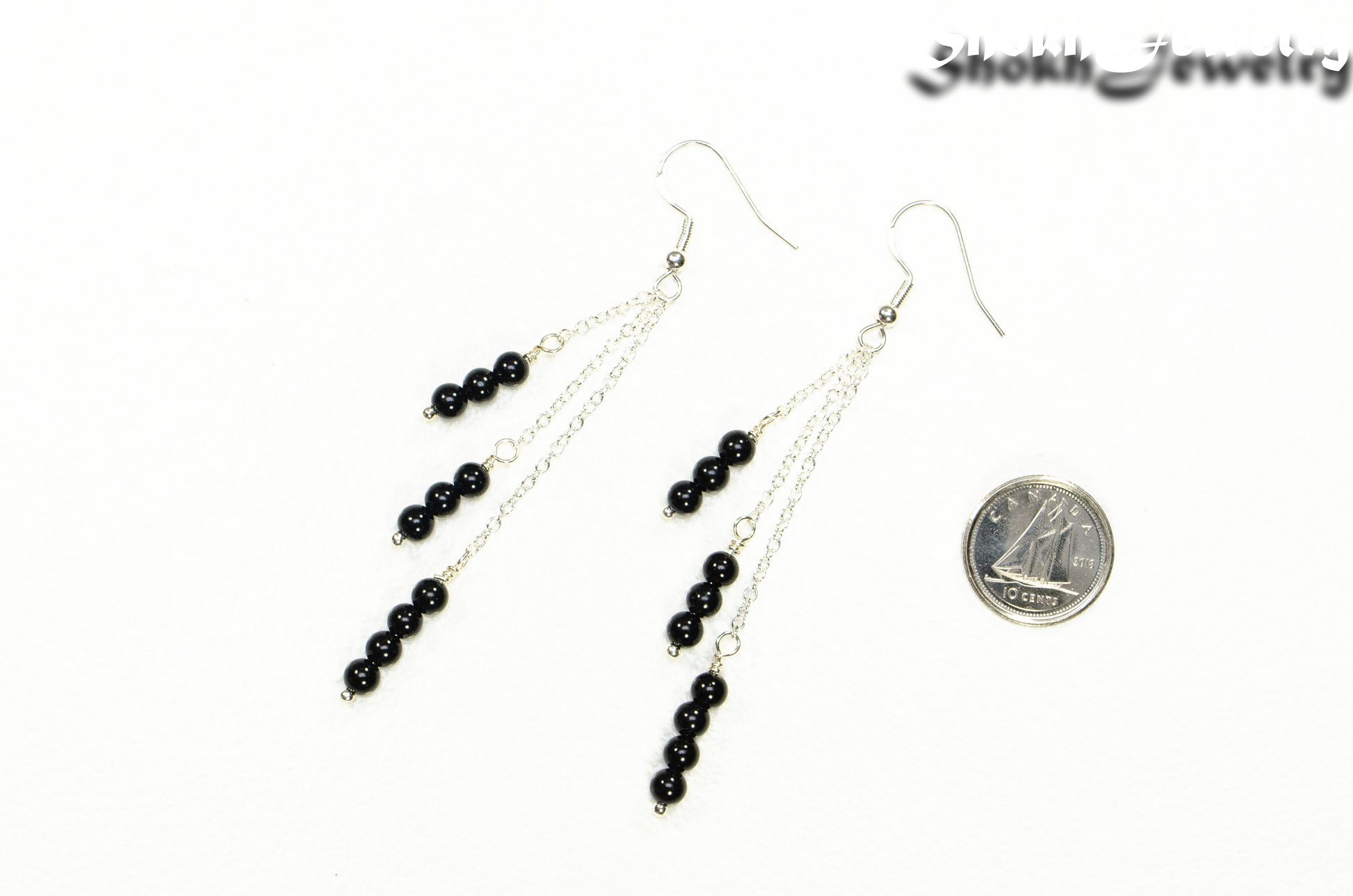 Silver Plated Chain and Black Obsidian Crystal Earrings beside a dime.