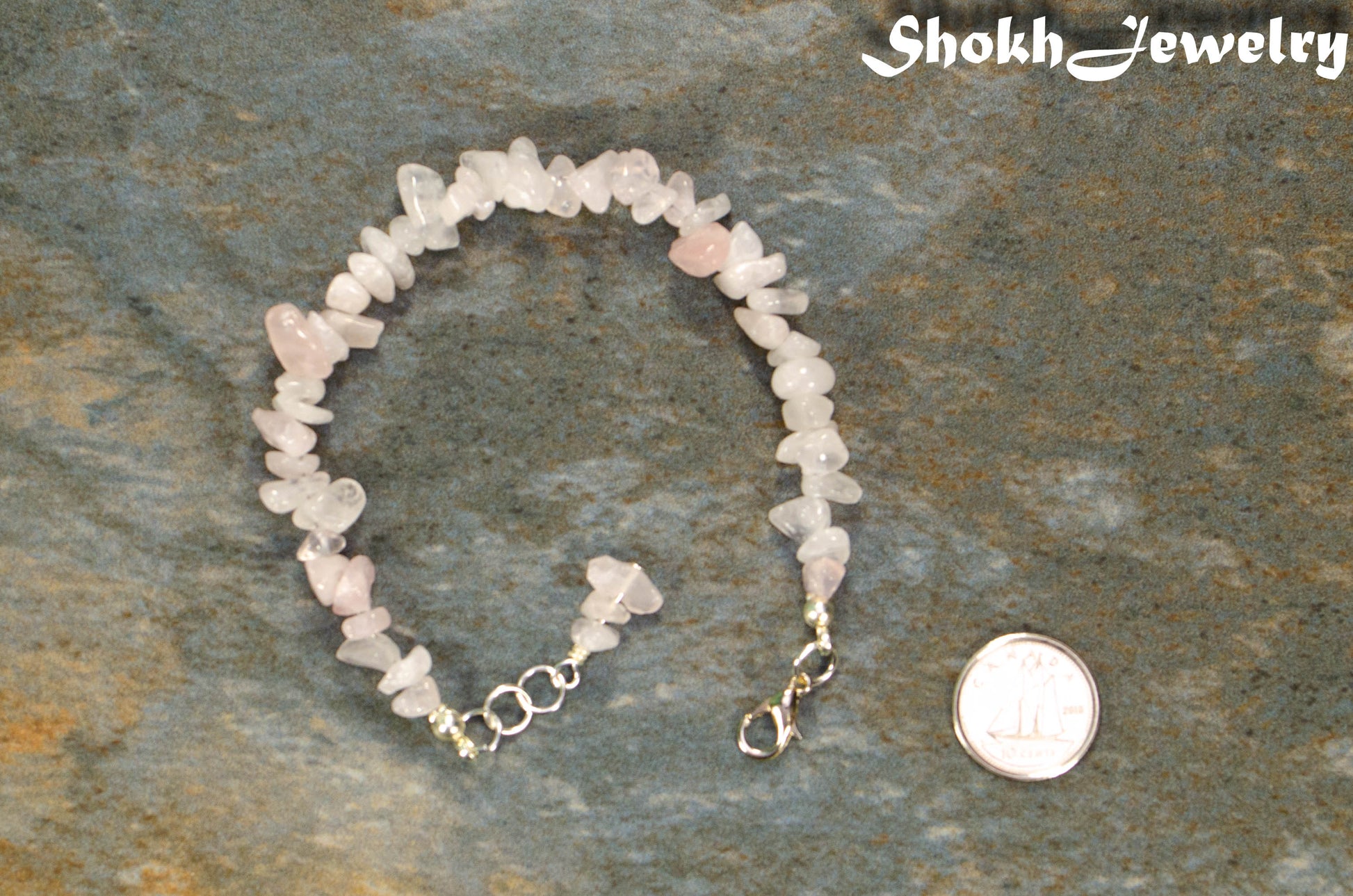 Natural Rose Quartz Crystal Chip Bracelet beside a dime.