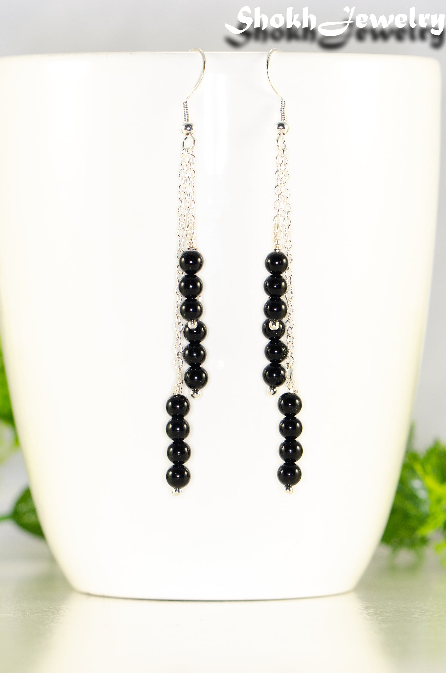 Close up of Silver Plated Chain and Black Obsidian Crystal Earrings.