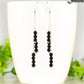 Silver Plated Chain and Black Obsidian Crystal Earrings displayed on a coffee mug.