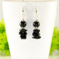 Simple  Black Obsidian Crystal Chip Earrings displayed on a tea cup.
