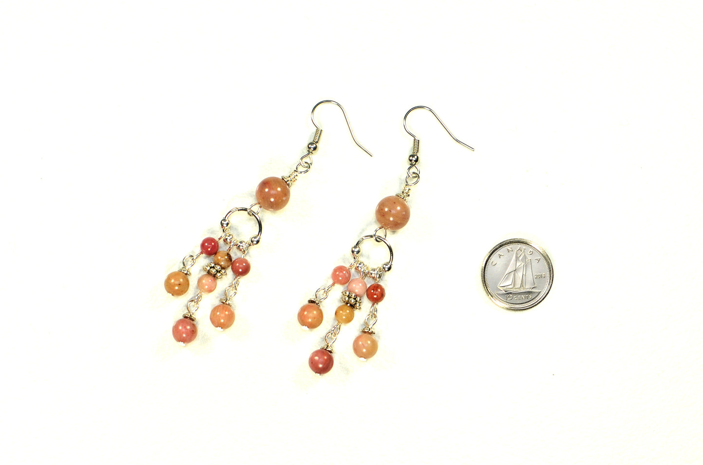 Statement Pink Rhodonite Chandelier Earrings beside a dime.