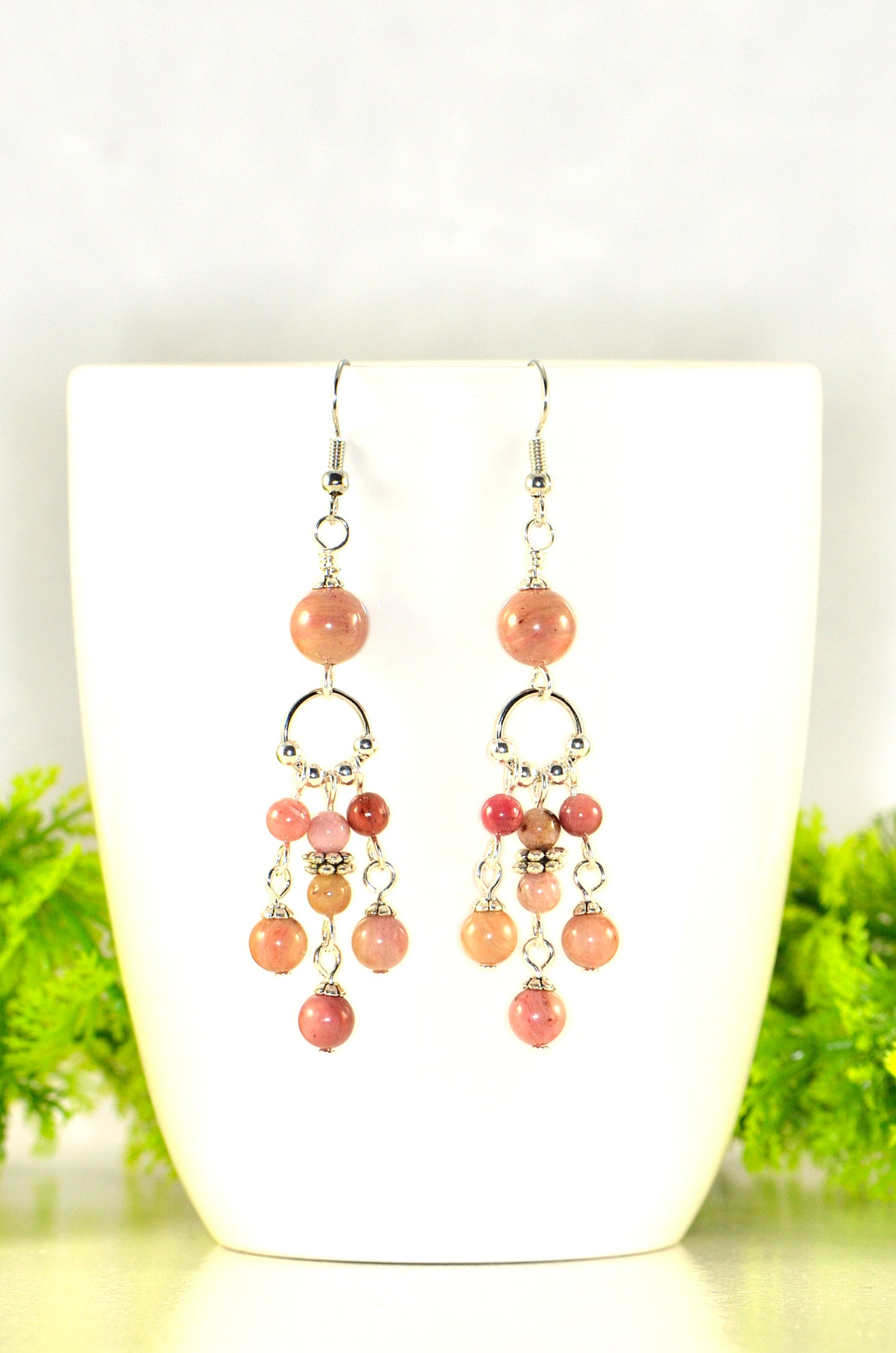 Close up of Statement Pink Rhodonite Chandelier Earrings.