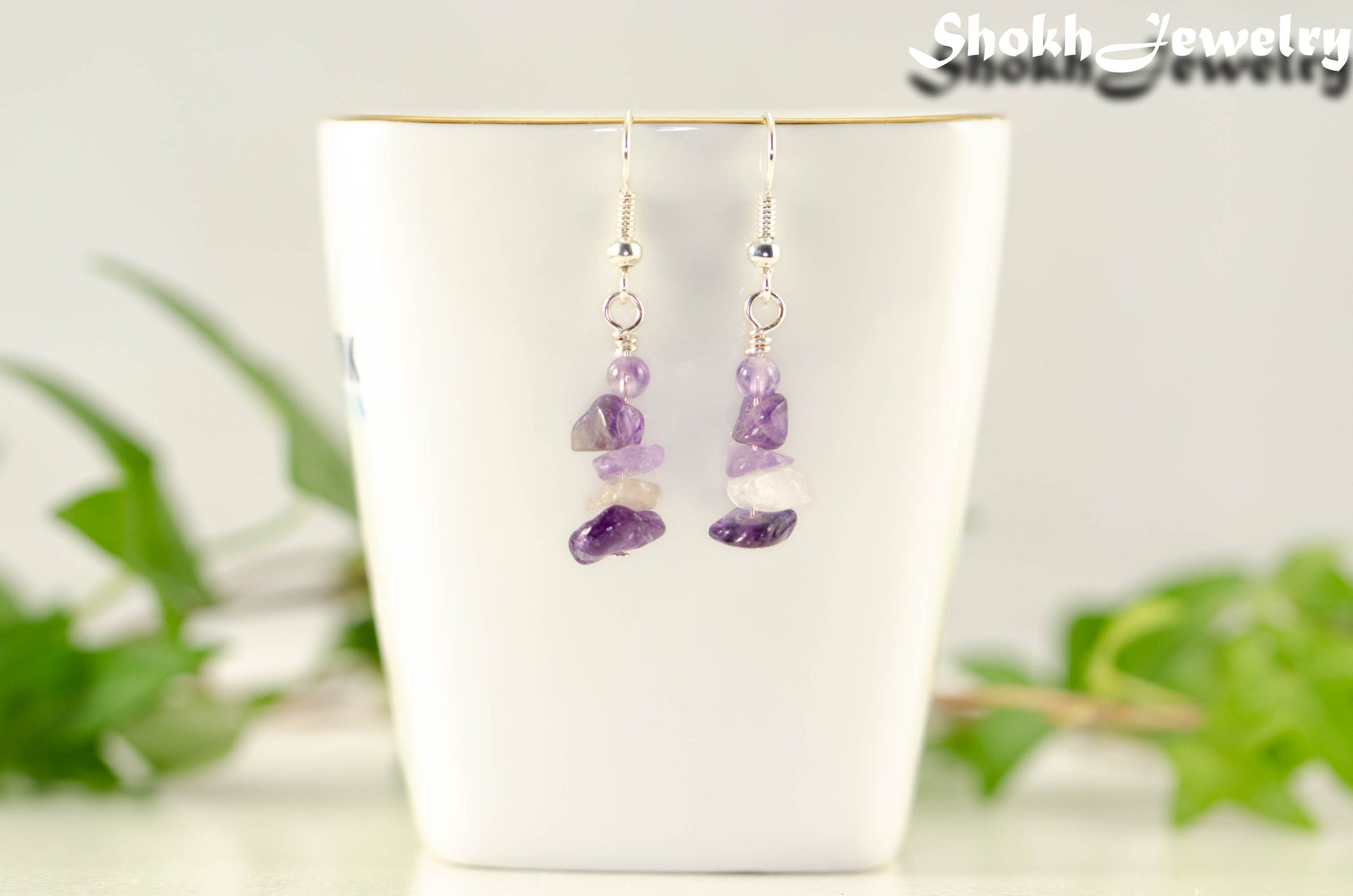 Natural Amethyst Crystal Chip Earrings on a tea cup