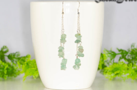 Long Silver Plated Chain and Green Aventurine Crystal Chip Earrings on a mug
