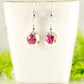12mm Ceramic Pink Flower Earrings displayed on a tea cup 
