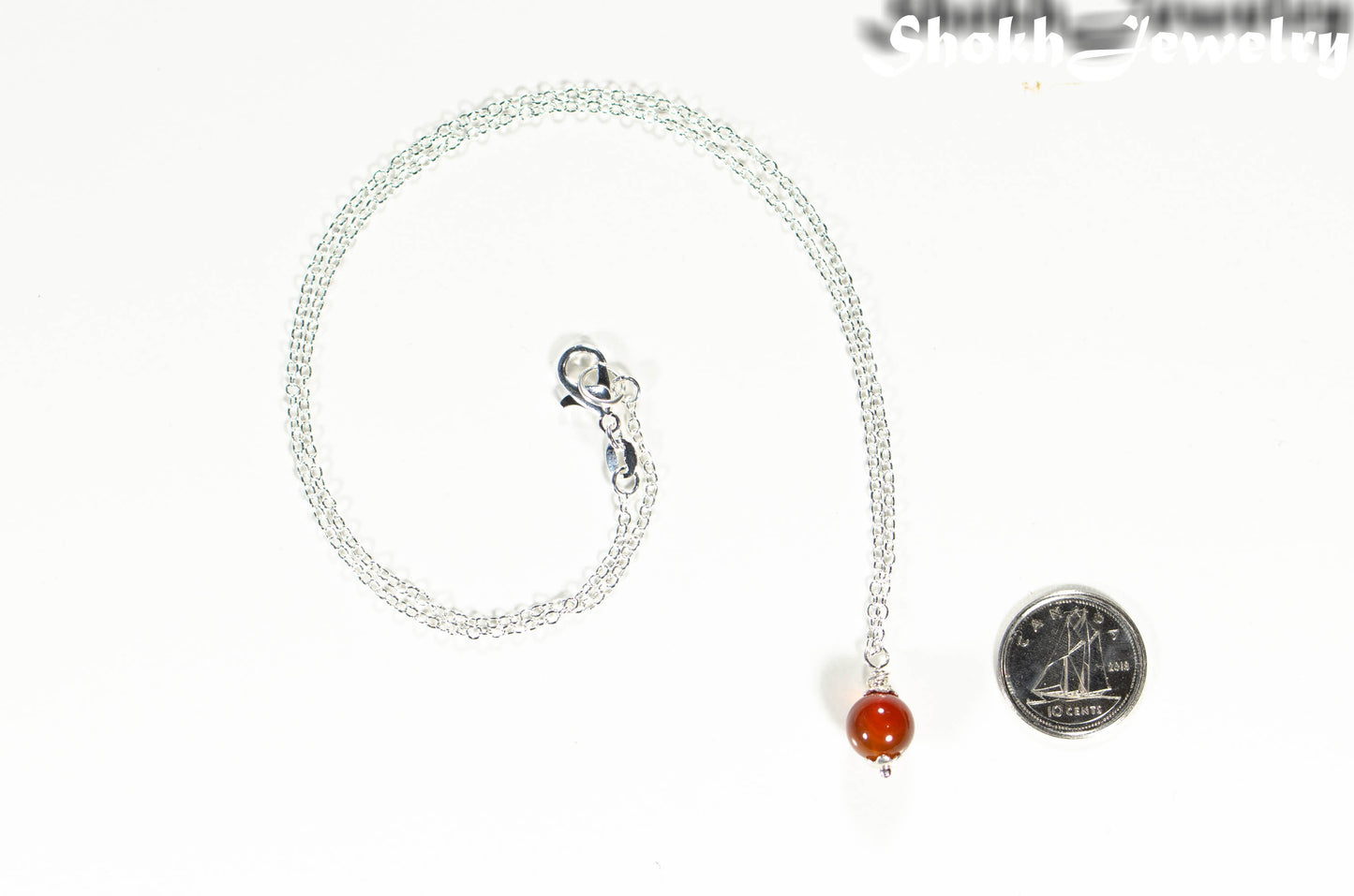 Dainty Carnelian Choker Necklace beside a dime